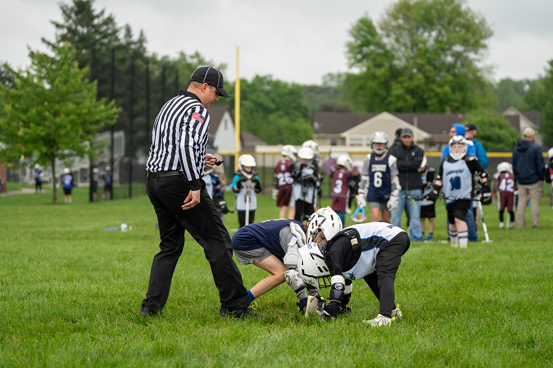 Ref at faceoff of youth game