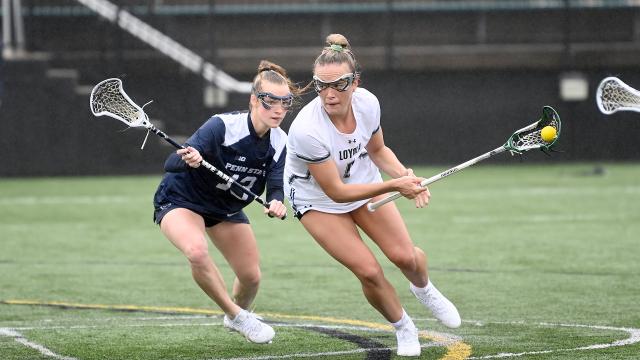 Loyola's Chase Boyle keeps the ball away from Penn State's Lauren Saltz