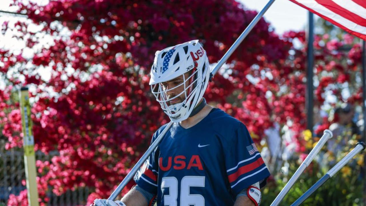 Jesse Bernhardt carries the U.S. flag.