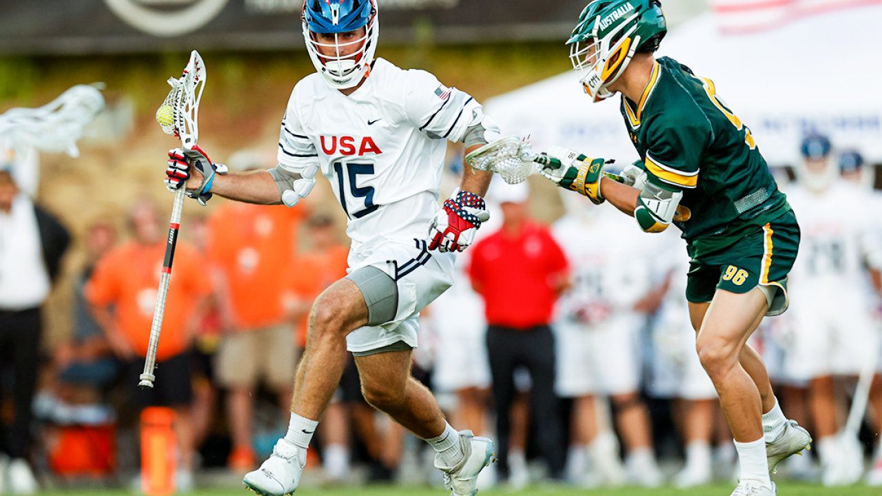 U.S. midfielder Ryan Conrad (15) evades Australia's Lucas Parsons Quintiao (96) during a World Lacrosse Men's Championship pool play game Friday at Torero Stadium in San Diego.