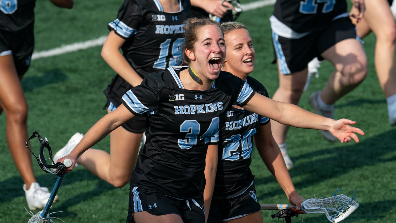 Johns Hopkins celebrates an OT win over Michigan.