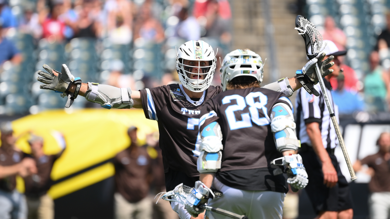 Tufts lacrosse players celebrate at the end of their NCAA championship game win over RIT.