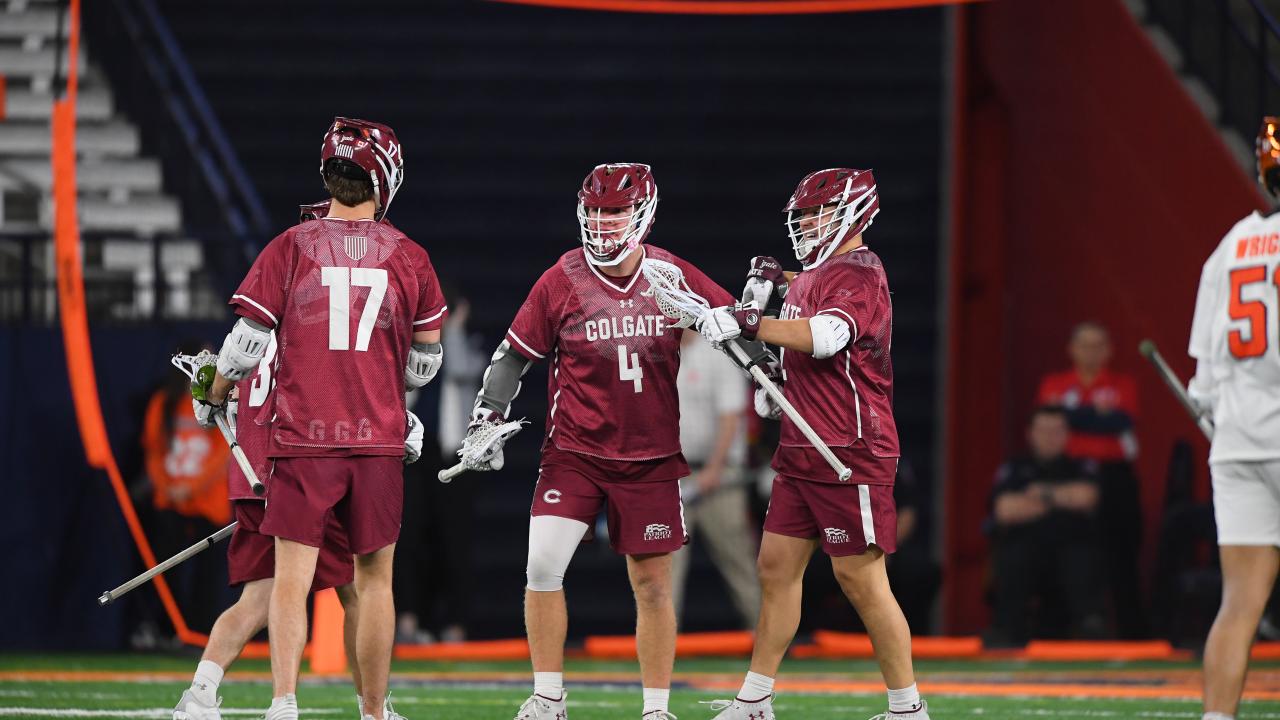 Colgate's Rory Connor (4) celebrates a goal with teammates at the JMA Wireless Dome during a game against Syracuse.